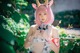 A woman with pink hair wearing a cow costume.