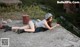 A woman laying on the ground with a gun.
